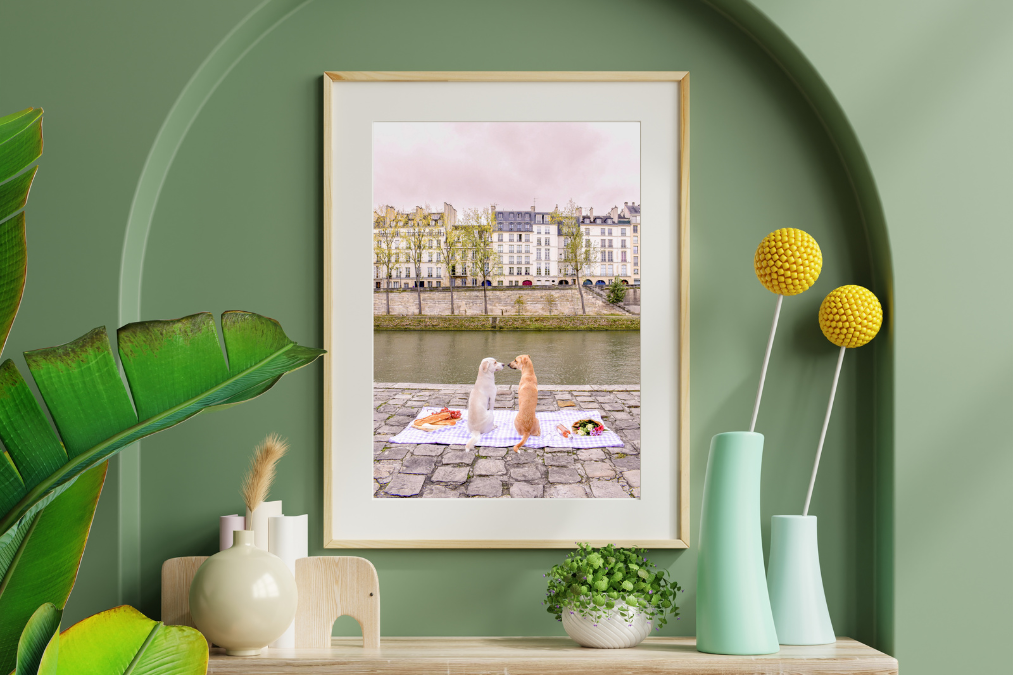 framed picture of dogs on a green wall