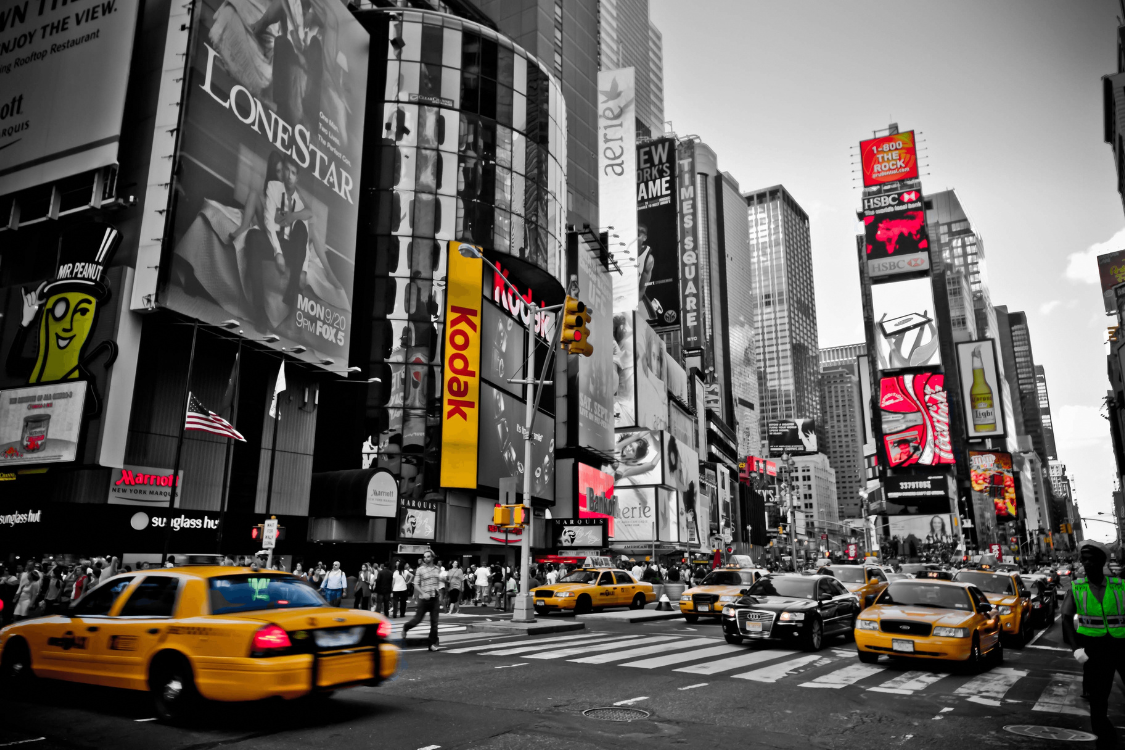 a cab driving across a busy new york city street