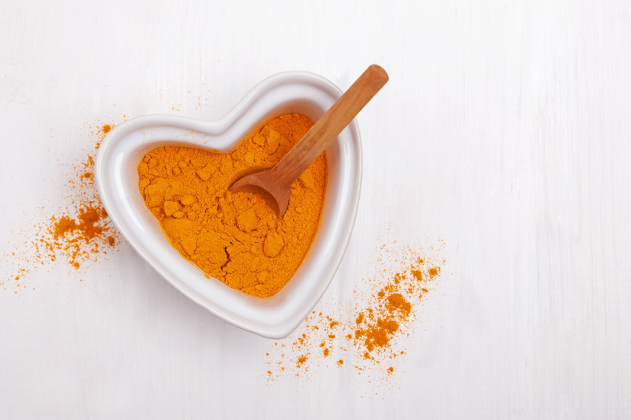 turmeric powder in a heart shaped bowl