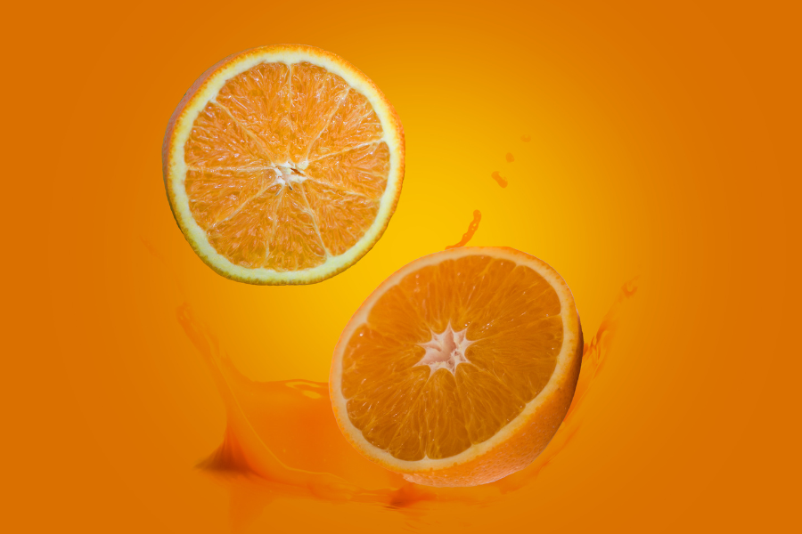 an orange cut in half floating