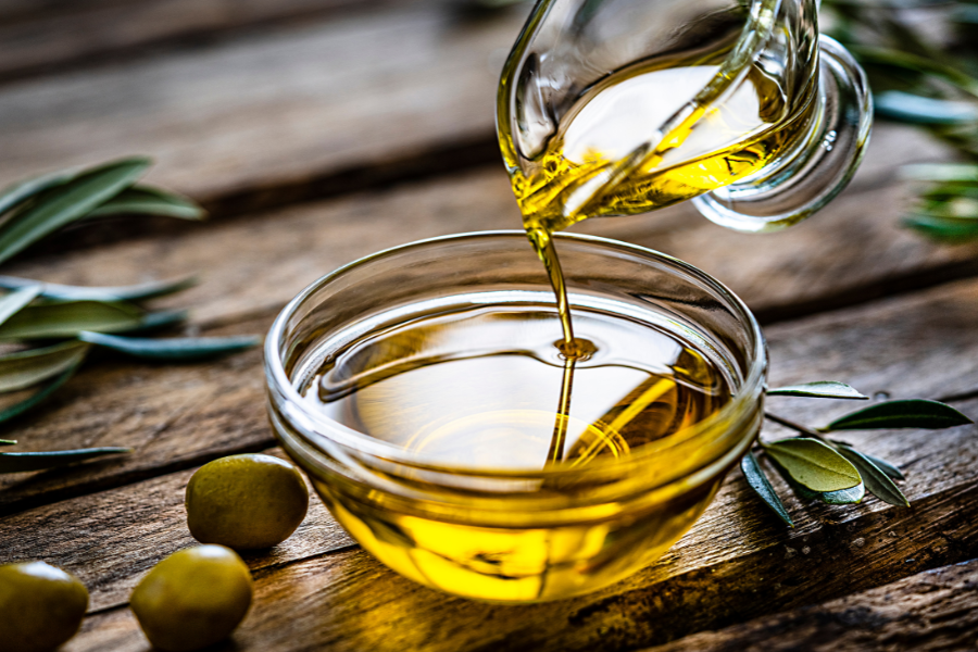 olive oil drizzling into a bowl