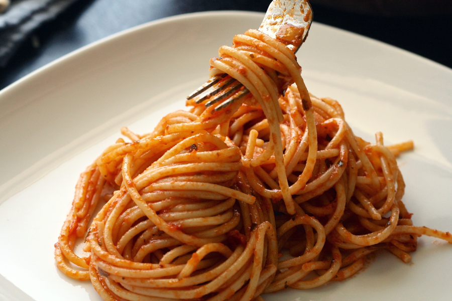 a plate of pasta with tomato sauce