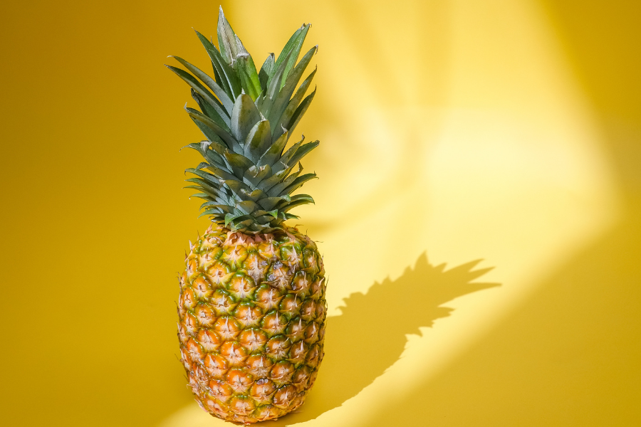a pineapple on yellow background
