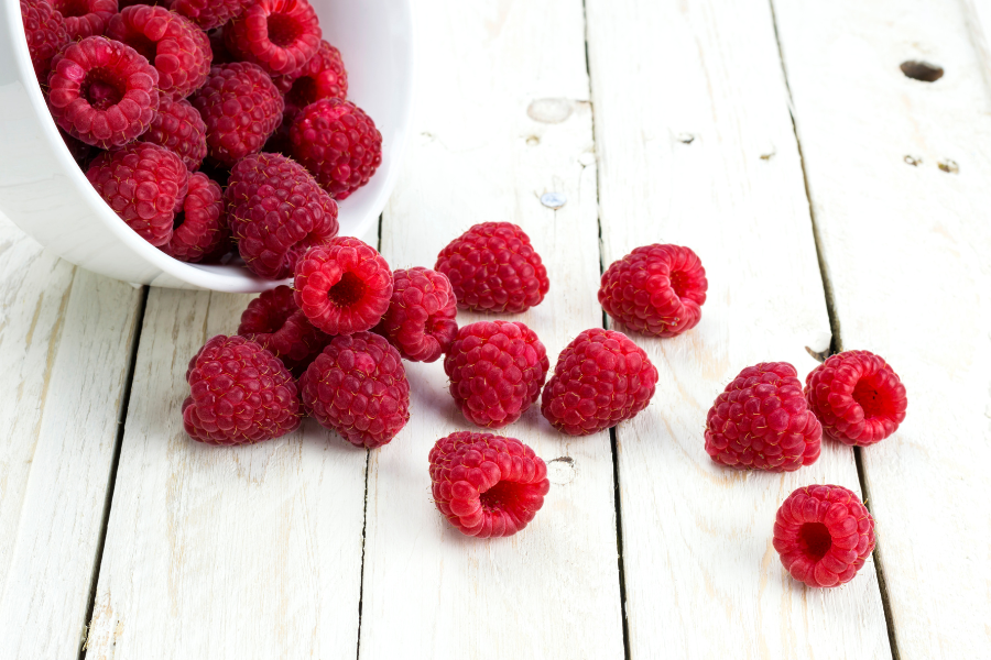 raspberries falling out of a bowl